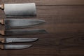 Kitchen knifes on the brown wooden background