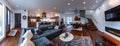 a kitchen and living room with wooden accents, featuring a panoramic view that includes stairs ascending to the second Royalty Free Stock Photo