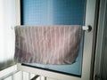 Kitchen microfiber cloth drying at the window mounted aluminium and pvc pipe towel rack. Home DIY project hack to the window