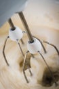 A kitchen mixer mixing sugar and water to form sweet icing for a