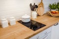 kitchen mockup with induction hob and wooden surface, copy paste