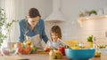 In Kitchen: Mother, Cute Little Daughter Cooking Together Healthy Dinner. Mother Teaches Little Gi Royalty Free Stock Photo