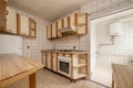 Kitchen with old furniture in wood and cream color, with vintage kitsch tiles