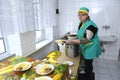 Kitchen, preparing food. Cook keeping plate with ready meal in hands. Center of social services for old people. Kyiv