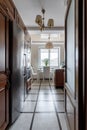 Kitchen with a quartz waterfall, wooden floors, dark wood cabinets and stainless steel appliances