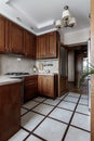 Kitchen with a quartz waterfall, wooden floors, dark wood cabinets and stainless steel appliances