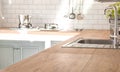 Kitchen room and background concept - blurred brown wooden top of kitchen counter with beautiful modern vintage kitchen room