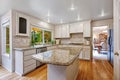 Kitchen room with white storage combination and island