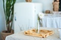 Kitchen in rustic style in summer. Spring light textured kitchen with an old fridge, wooden table. Wooden glass vase with one whit Royalty Free Stock Photo