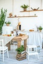 Kitchen in rustic style in summer. Spring light textured kitchen with an old fridge, wooden table. A wooden tray with a vase, will Royalty Free Stock Photo