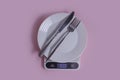 Kitchen scales, empty plate cooking   a colored background Royalty Free Stock Photo