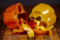 Bell peppers, whole and sliced on a wooden cutting board Royalty Free Stock Photo