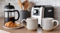 Kitchen scene with coffee maker, mugs, and pastries. Royalty Free Stock Photo