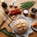 Kitchen scene featuring a round artisanal loaf of bread with a cross Royalty Free Stock Photo