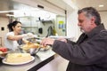 Kitchen Serving Food In Homeless Shelter Royalty Free Stock Photo