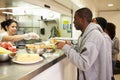 Kitchen Serving Food In Homeless Shelter