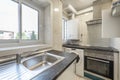 Kitchen set in an antique terrace of smooth, glossy white cabinets with stainless steel pulls, a black countertop and built-in Royalty Free Stock Photo