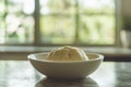 In a kitchen setting, dough rises within a round metal bowl, illustrating the bread-making process during morning hours Royalty Free Stock Photo