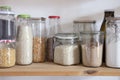 Kitchen shelf with glass Jars full of dried Food. Eco friendly food storage