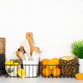 Kitchen shelf storage organization fruit cutlery. Home style minimalism zero waste. Still life with storage baskets of Royalty Free Stock Photo