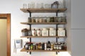 Kitchen shelves with various food ingredients and spices,