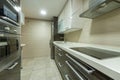 Kitchen with Silestone countertop with ceramic hob with extractor hood Royalty Free Stock Photo