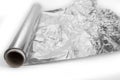 Kitchen silver foil in the rool on a white Royalty Free Stock Photo