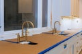 Kitchen with sink cabinets in new luxury home three kitchen sinks Royalty Free Stock Photo