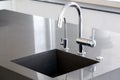 Kitchen sink of dark gray stone with chrome faucet. Royalty Free Stock Photo