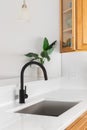 Kitchen sink detail shot with marble countertop.