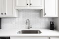 A kitchen sink detail with a white subway tile backsplash. Royalty Free Stock Photo