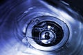 The bottom of a kitchen sink with a popup drain is filled with clear blue water Royalty Free Stock Photo