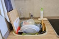 The kitchen sink was full of dirty unwashed dishes