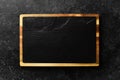 Kitchen slate black board. On a black stone background. Royalty Free Stock Photo