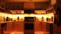 Kitchen with soft, glowing under-cabinet lights. . Royalty Free Stock Photo