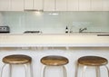 Kitchen splashback bench and stools Royalty Free Stock Photo