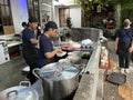 Kitchen staff preparing traditional Japanese ramen