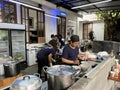 Kitchen staff preparing traditional Japanese ramen