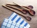 Kitchen still life with cooking spoons and dishcloths on wooden table Royalty Free Stock Photo