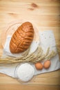 Kitchen still life from flour, wheat ears, bread and eggs Royalty Free Stock Photo