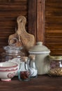 Kitchen still life. Olive chopping board, glass jar with flour, vintage utensils - bowl, Cup, pot and jars of spices and homemade Royalty Free Stock Photo