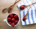Kitchen still life with strawberries, cooking spoons and dishcloths on wooden table Royalty Free Stock Photo
