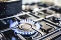 Kitchen stove cook. Kitchen gas cooker with burning blueflames fire propane gas. Royalty Free Stock Photo