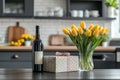 The kitchen table features a vase of beautiful tulips, a gift box, a bottle of wine, and glasses Royalty Free Stock Photo