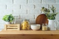 Kitchen table with food jars and plants over white brick wall background. Kitchen mock up for design and product display Royalty Free Stock Photo