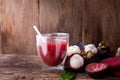 Kitchen table with glass of fresh mangosteen juice