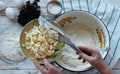 Kitchen table with ingredients for making semolina pie.Hands of an elderly woman kneading dough.Food pastry background. Royalty Free Stock Photo