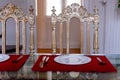 The kitchen table porcelain plates fork , knife , and two vintage chair against the window