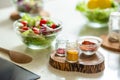 Kitchen table with salad spices and wooden spoonula Royalty Free Stock Photo