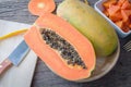 Kitchen table with slice fresh papaya on wood plate, Fruit for t Royalty Free Stock Photo